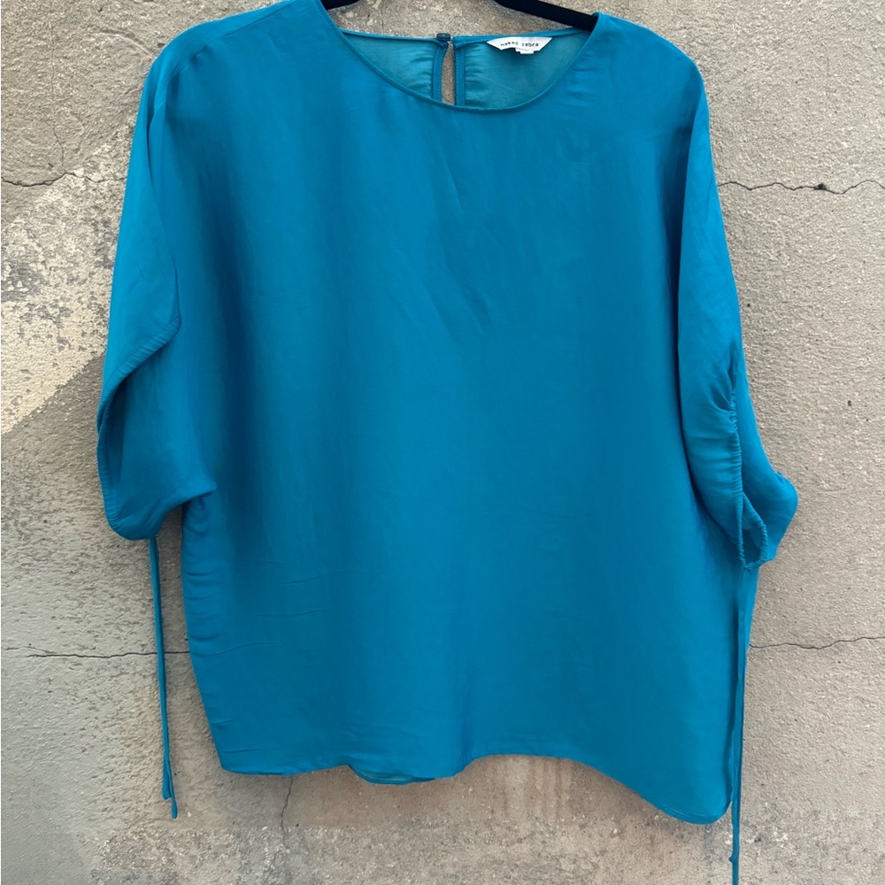 Naked Zebra top. Turquoise. Size Medium. Dolman sleeve. Draw string bottom.